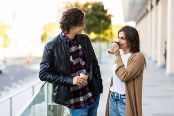 Pretty couple in love drinking coffee on the street cafe having fun together outdoor