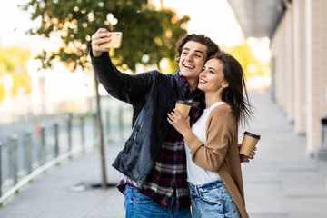 Young couple taking selfie in the city. Fun time.