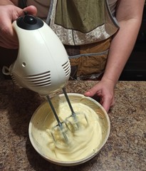 confectioner mixing cream for cake with mixer