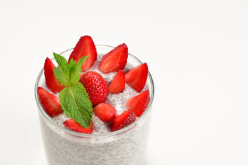 Chia pudding with strawberry and mint on a white background. Space for text or design.