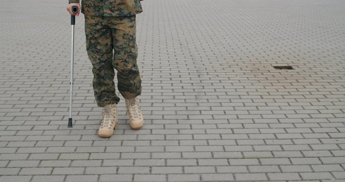 Cropped view of soldier walking with injury.