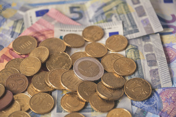 Pile of Euro coins on euro bank money notes of 5, 10 and 20 euro. 