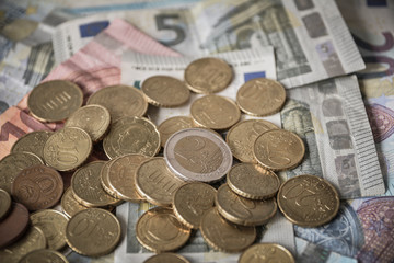 Pile of Euro coins on euro bank money notes of 5, 10 and 20 euro. 