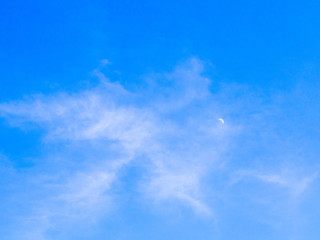 Naklejka na ściany i meble cloudy sky in day time with haft moon, blue sky background