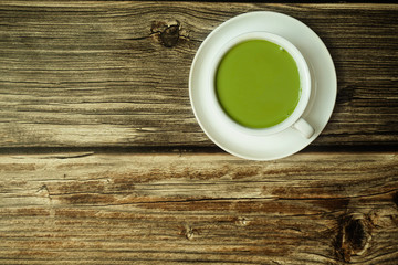 Fototapeta na wymiar Top view green tea latte on wooden table