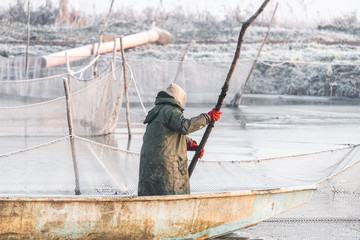 two fishermen and nets at a deep temperature minus