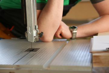 Worker using electric saw portrait