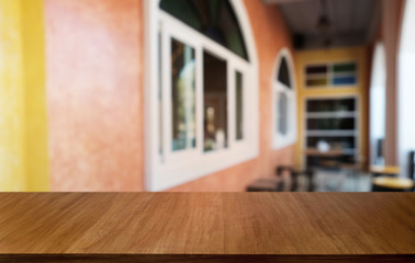 Empty dark wooden table in front of abstract blurred bokeh background of restaurant . can be used for display or montage your products.Mock up for space.