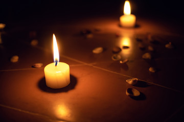 pentagram is painted on the floor, candles are lit, beads are lying, shells are scattered. concept...