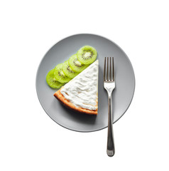 Homemade cottage cheese cake with kiwi fruit and cream on a plate isolated on white background with clipping path