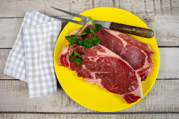 raw beef ribeye on a plate