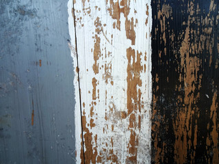 Rustic wood plank painted with three colors: gray, white and black