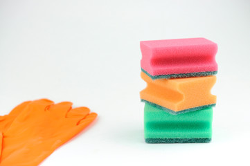 three sponges for washing dishes and rubber gloves