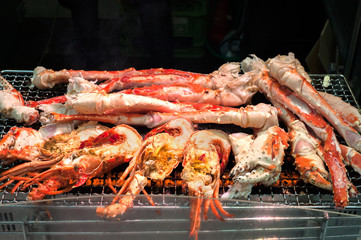 Grilled shrimp and crabs at Kuromon Ichiba Market, Osaka, Japan
