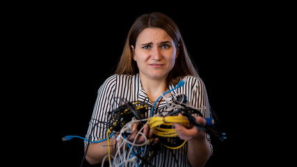 junge Frau ist mit Kabelsalat und Technik überfordert und hat Angst