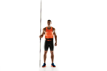 Male athlete practicing in throwing javelin isolated on white background. Professional sportsman, thrower posing confident. Concept of healthy lifestyle, movement, activity, competition. Copyspace.