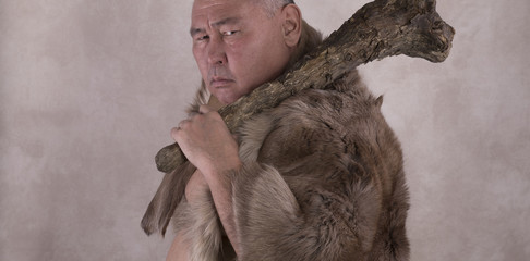 ancient caveman in the skin and with a club