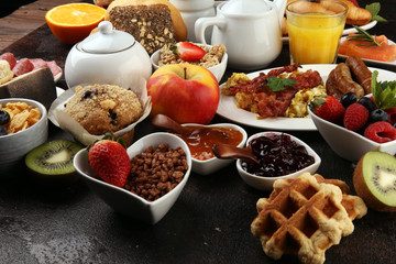 Breakfast served with coffee, orange juice, croissants, cereals and fruits. Balanced diet. Continental breakfast with granola and fruits