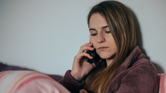 junge Frau telefoniert und ist in Gedanken vertieft