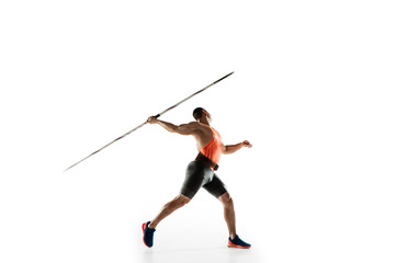 Male athlete practicing in throwing javelin isolated on white studio background. Professional sportsman training in motion, action. Concept of healthy lifestyle, movement, activity. Copyspace.
