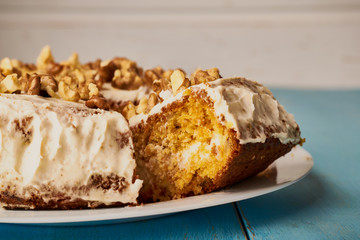 Closeup of a slice of homemade carrot cake dessert on a white plate