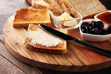 Toast bread on rustic table served with butter for breakfast or brunch. Toasted bread