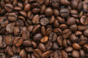 Close up view of brown roasted coffee beans. Blend of 70% arabica and 30% robusta is used for this photo. Theme of drinks ingredients. Coffee background.