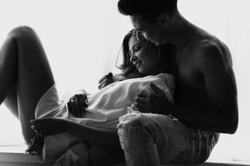 black and white photo of happy morning of Young romantic couple in love have fun, kissing and hugs. Love and relationships lifestyle.