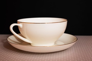 white tea cup and saucer