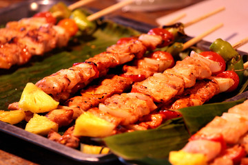 Thai street food at outdoor night market in Bangkok, Thailand.