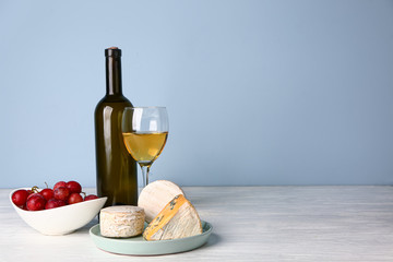 Fresh cheese with wine on white table