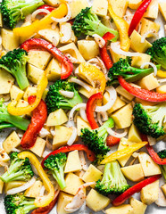 Raw chopped vegetables on a baking sheet. Cooking a vegetarian lunch