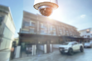 CCTV Security camera with townhome on background.