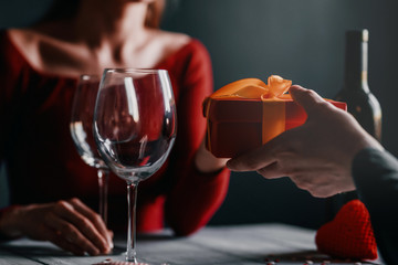 Congratulation concept for valentines day. couple at the table in a restaurant. dim lights, lovers...