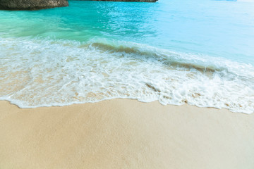 Soft wave of blue ocean on sandy beach. Background. copy space