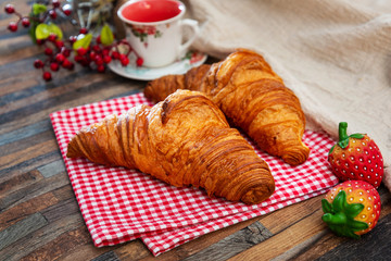 Delicious fresh croissant on table