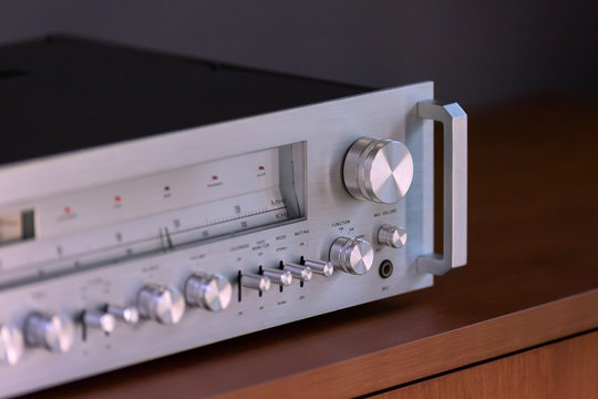Vintage Stereo Receiver Standing on the Wooden Sideboard, Side View
