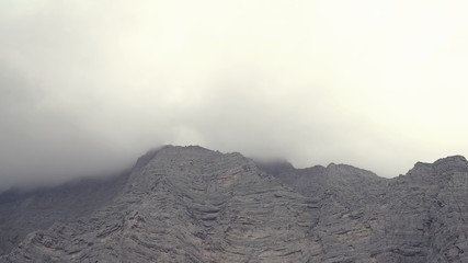 Mountain landscape moving clouds in Ras al Khaimah uae , fog and mist on layer mountain range low angle view Landscape, uae nature ,ras al Khaimah Mountains