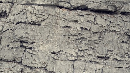Rough split face stone texture. Rock texture, Background texture of stone wall. Natural stone, a wall of natural stone.