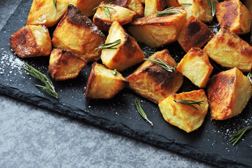Baked potato slices. Rosy slices of french fries with salt.