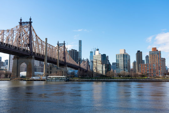 Queensboro Bridge along the East River with the Midtown Manhattan and Roosevelt Island Skyline in New York City
