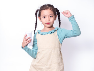 Little Asian cute girl 6 years old holding and drinking milk from carton of milk with rise one hand...