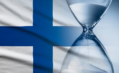 Flag of Finland with superimposed hourglass conceptual of deadlines