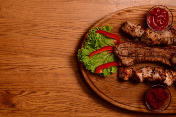 Sliced grilled beef barbecue Striploin steak with chimichurri sauce on cutting board on dark wooden background