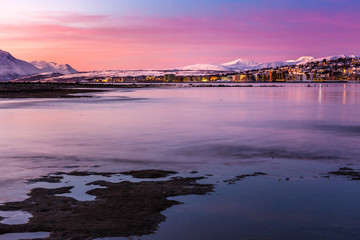 Amazing sunrise with amazing magenta color over Tromso, Norway. Polar night. long shutter speed