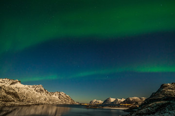 Obraz na płótnie Canvas winter landscape with aurora, sea with sky reflection and snowy mountains. Nature, Lofoten, Aurora borealis. Lofoten islands, Norway.