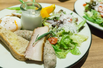 Fototapeta na wymiar ham and saucesage plate with salad