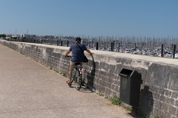 man on cycle in bike path in La Rochelle Charente France