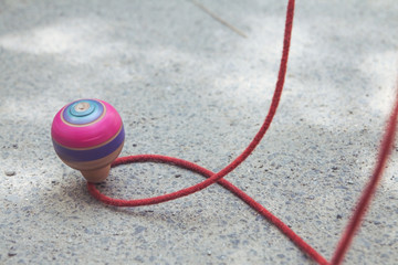 Classic wooden spinning top toy with string