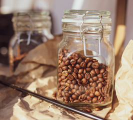 Beans of roasted coffee in a glass jar